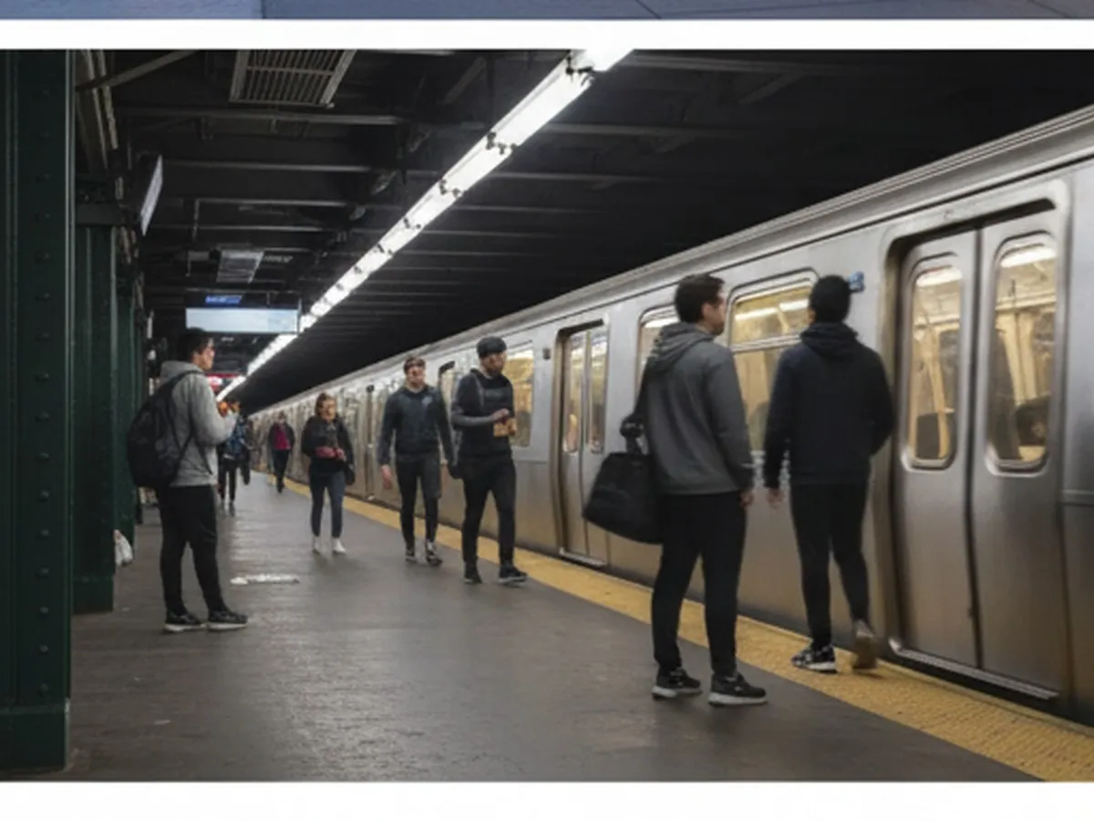 Early morning shot of a quiet subway platform in NYC with a few commuters in workout clothes waiting near a train, soft light filtering in, station signage visible but unreadable, suggesting an easy ride to a nearby gym.