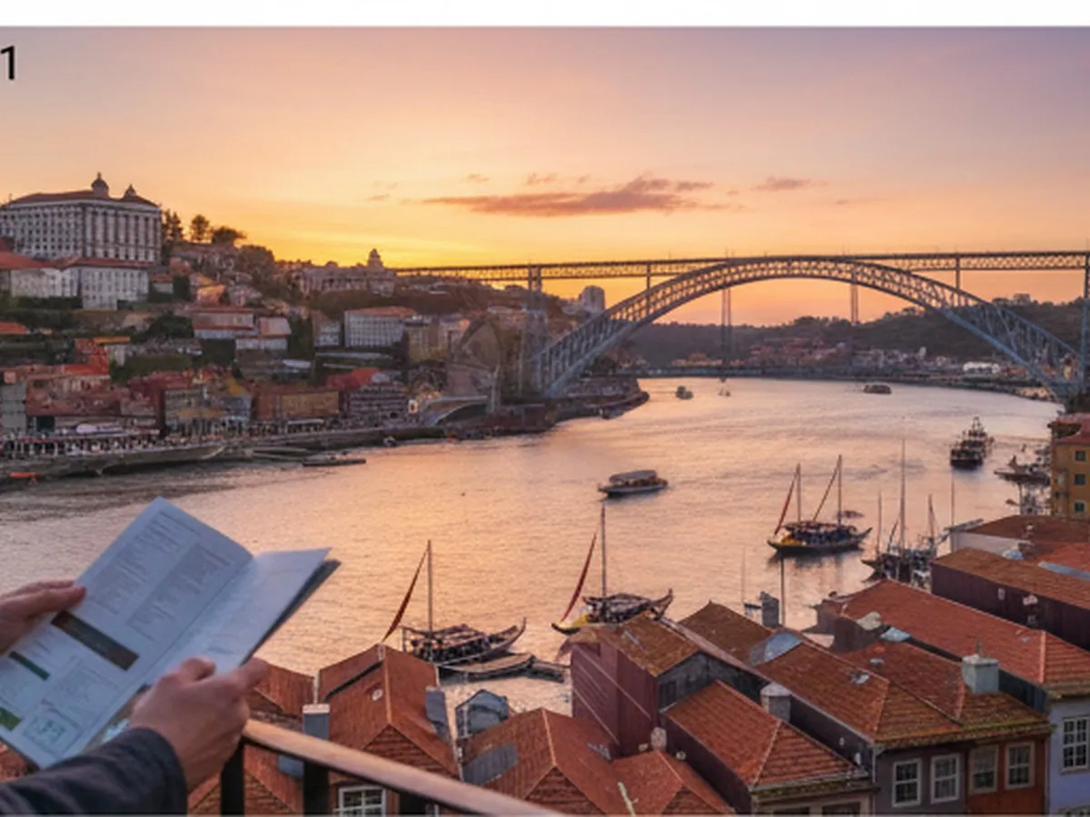Golden-hour view over Porto’s Ribeira district and the Douro River, shot from a high vantage point, with tiled buildings, boats on the water, and a distant iron bridge, framed as if seen by a New Yorker imagining their next trip abroad.