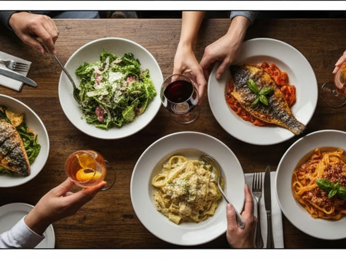 Close-up overhead shot of a rustic wooden table at Via Carota, filled with photorealistic Italian dishes like insalata verde, cacio e pepe, grilled fish, and Negroni cocktails, with diners’ hands reaching in, passing plates, and clinking glasses.