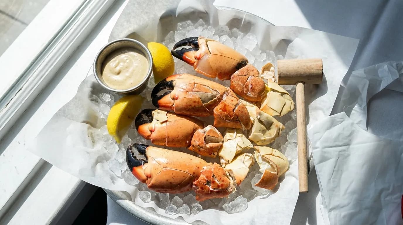 Cracked stone crab claws on crushed ice with mustard sauce