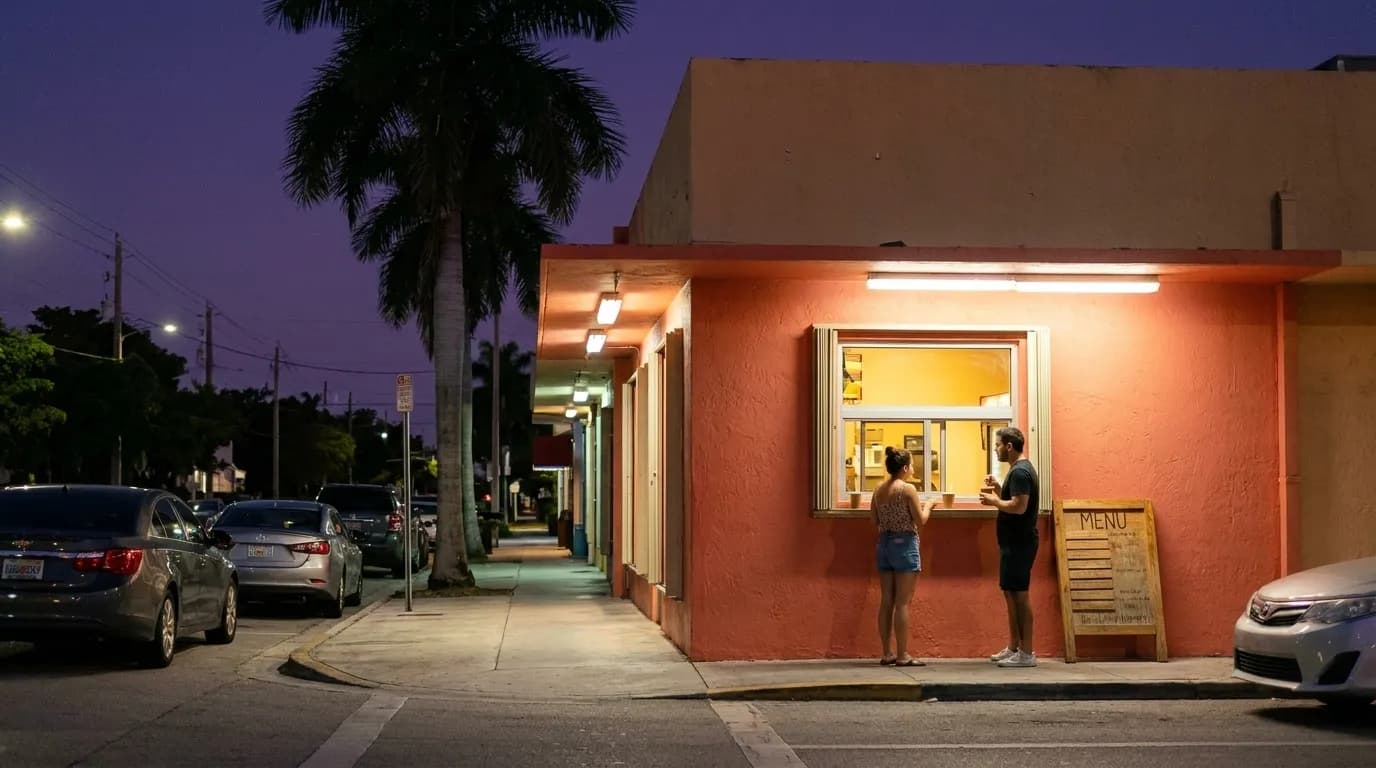 A Little Havana street at night with a lit restaurant window