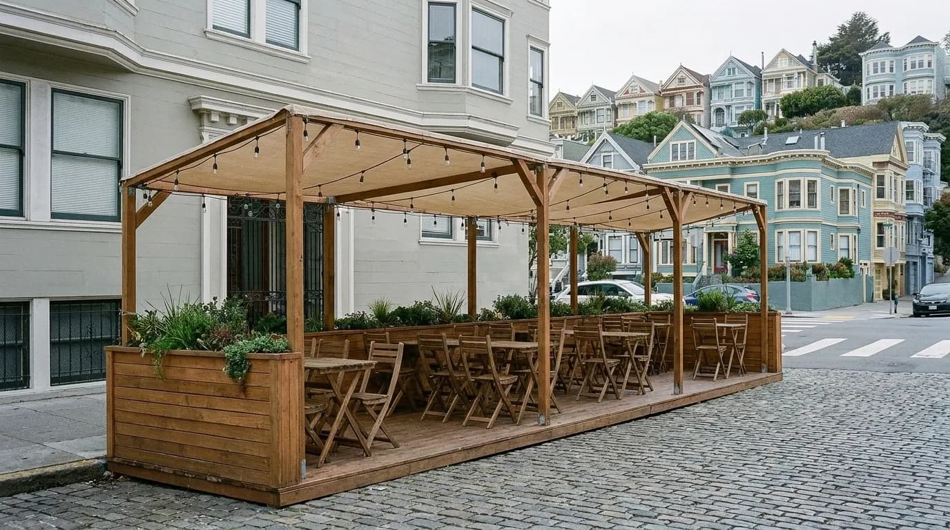 A timber parklet with tables built out over two parking spaces