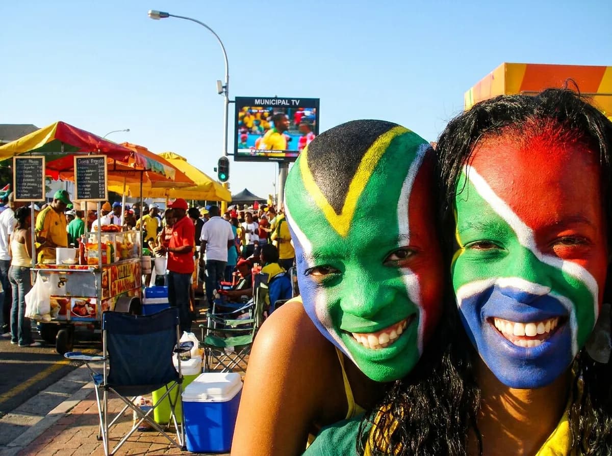 Corona street food carts cluster around public TV mounts during World Cup, turning sidewalks into makeshift match-day markets - World Cup 2026