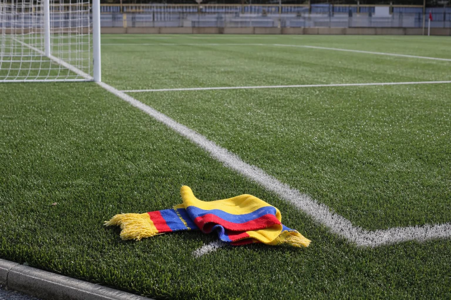 Bright realistic football pitch image with Colombia-colored scarf for 1994 World Cup context