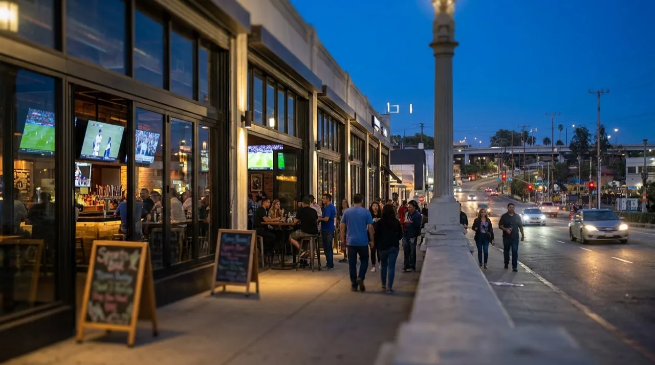 Evening street view of Downtown Los Angeles sports bars with warm interior glow and pedestrian traffic