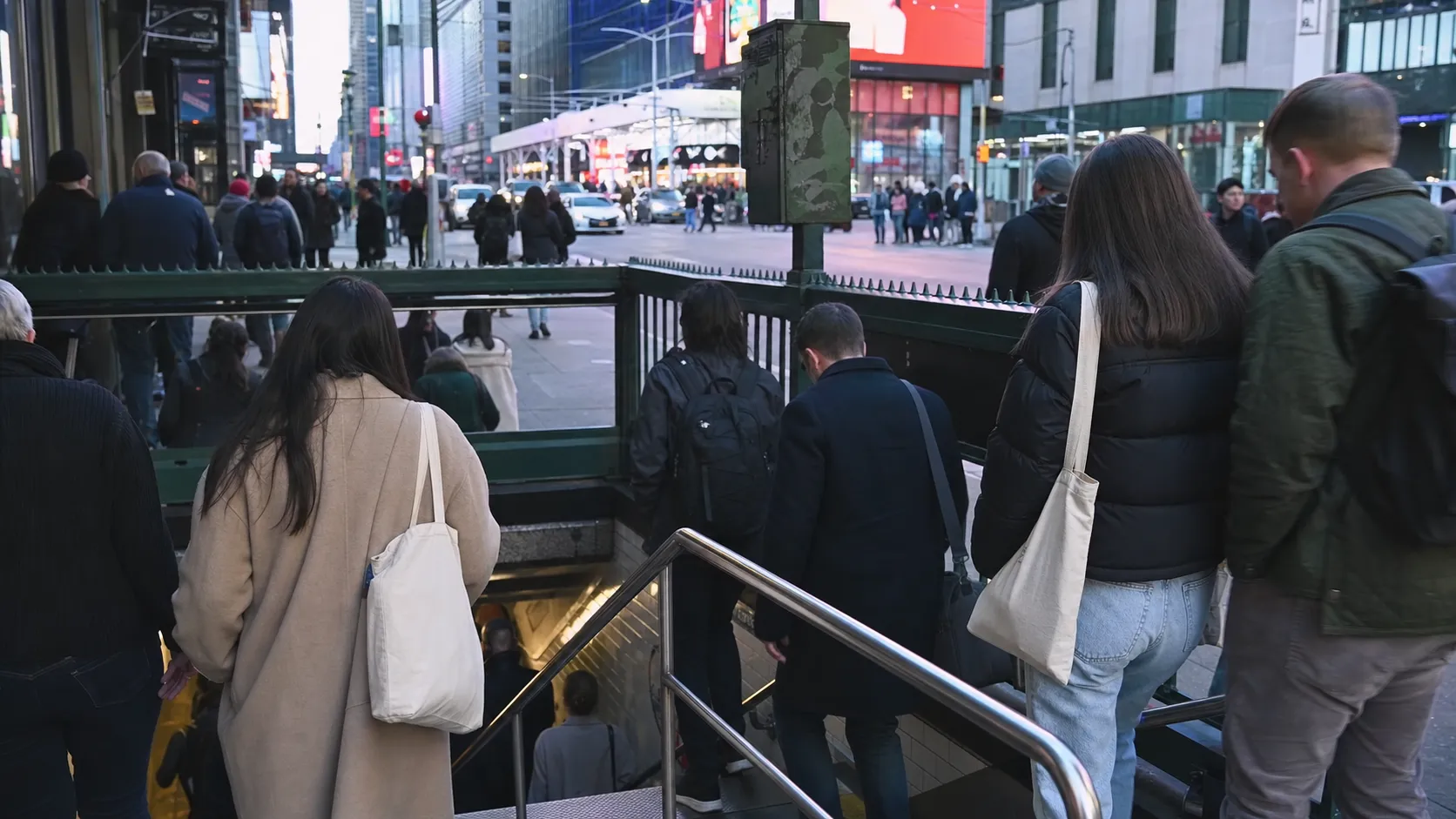 Moviegoers near a Times Square subway entrance on the way to a cinema.