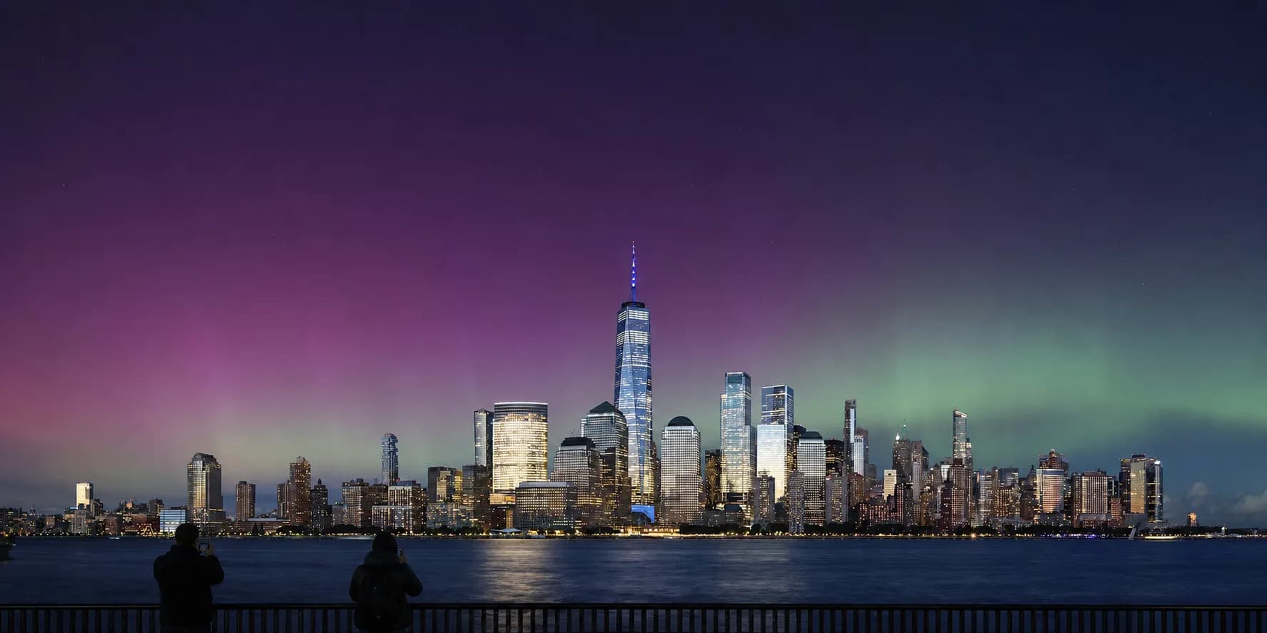 A rare aurora glow above Lower Manhattan viewed from the waterfront