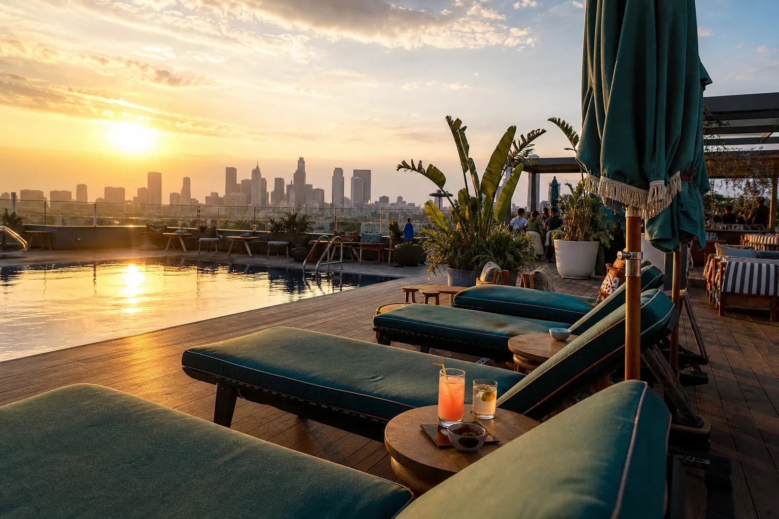 Vibrant pool deck at Cabra on the roof of The Hoxton in Los Angeles during evening golden hour.