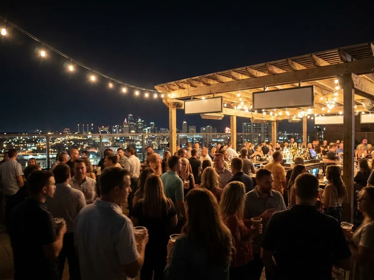 A rooftop club at night with a bar under a pergola strung with lights and the city glittering beyond a glass parapet
