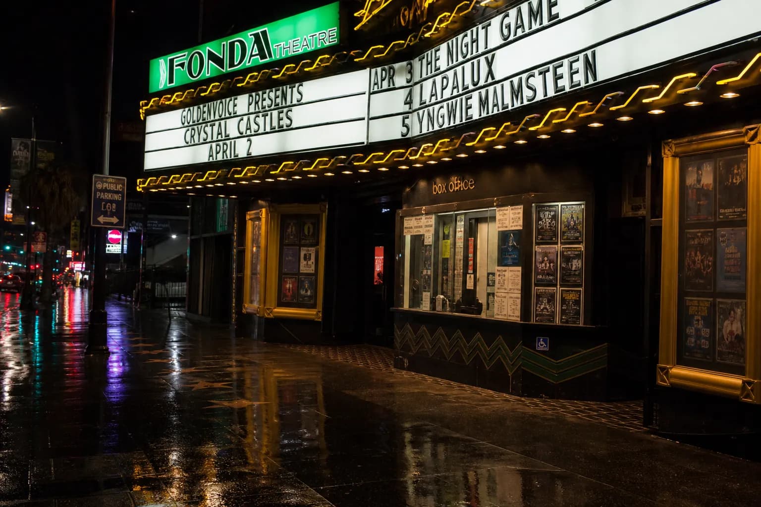 The glowing neon ticket window of the historic Fonda Theatre on Sunset Boulevard at night.