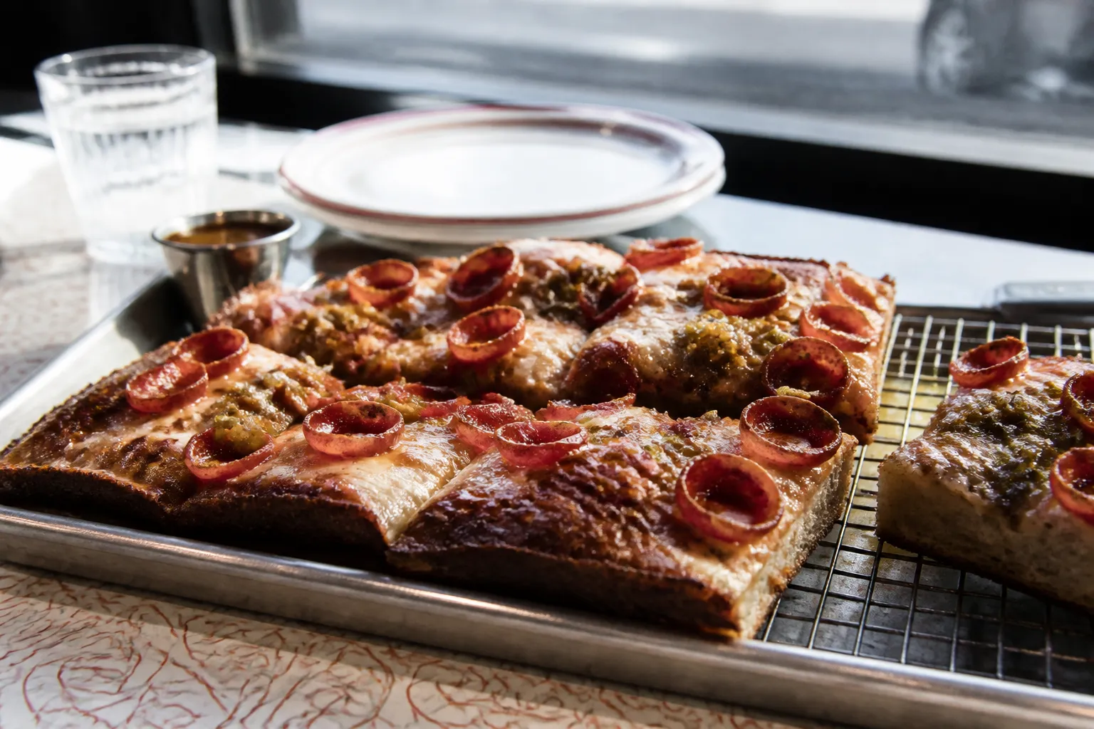 Thick Sicilian-style pan pizza topped with pepperoni slices on a metal tray at Quarter Sheets Echo Park