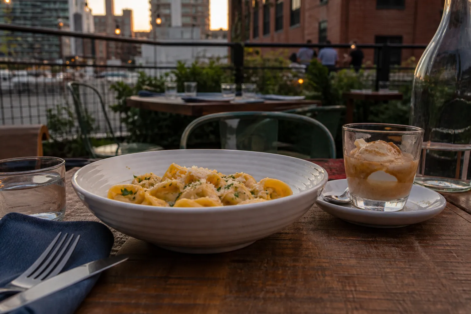 A outdoor dining table at a DTLA Italian restaurant featuring handmade pasta and an affogato dessert
