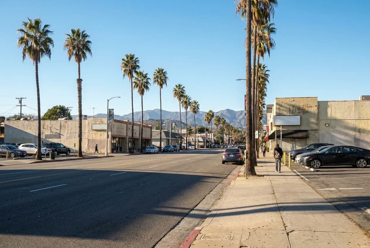 Ventura Boulevard street view in Sherman Oaks with palm trees, commercial buildings, and distant mountains under afternoon light