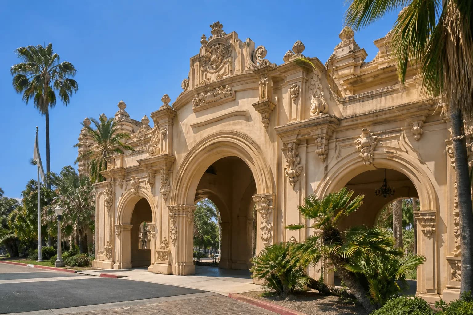 Beautiful Spanish Colonial Revival arches and palm trees at the entrance of Balboa Park in San Diego.
