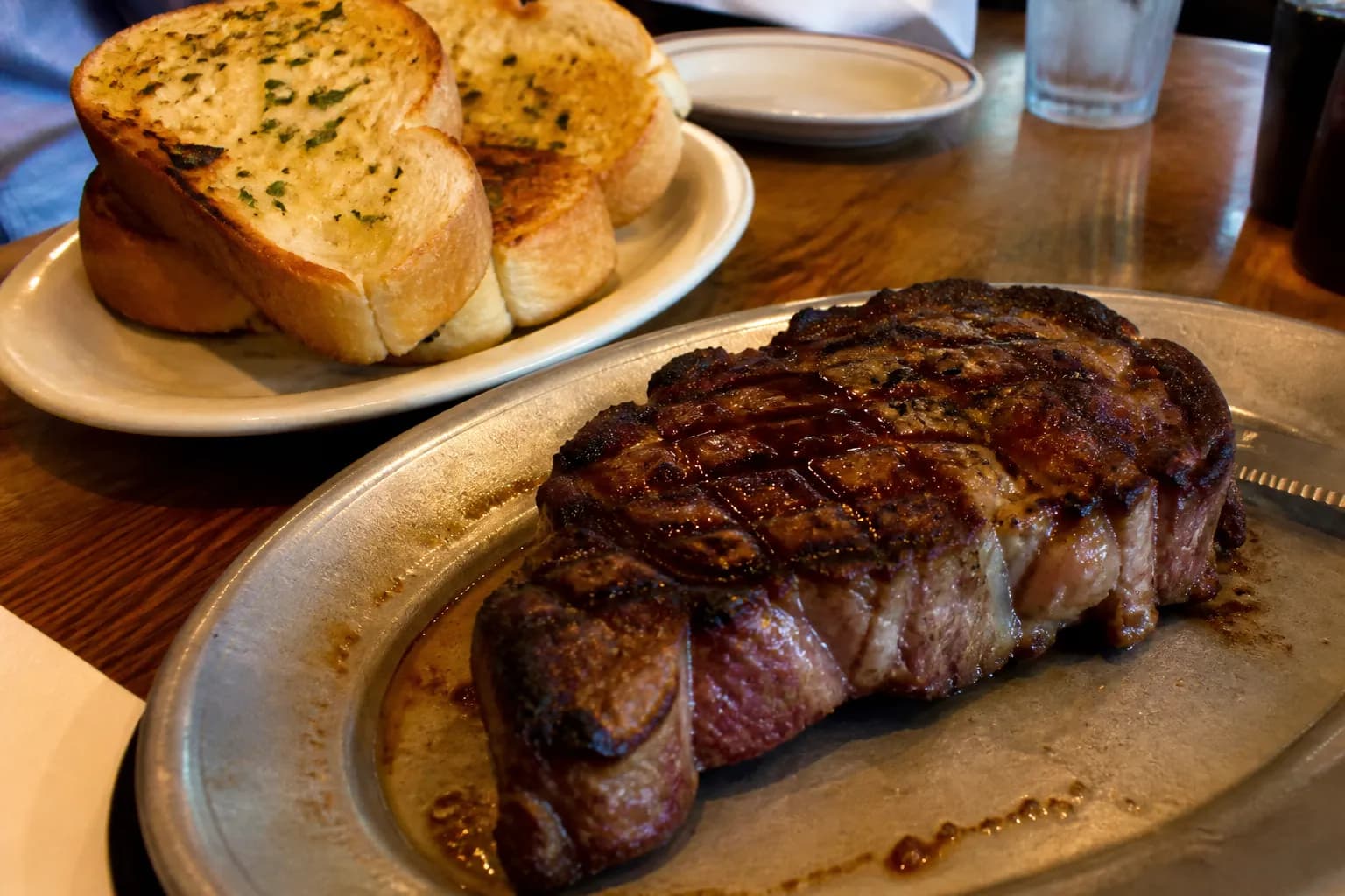 Tender sirloin steak served with thick-cut golden garlic toast at Damon's