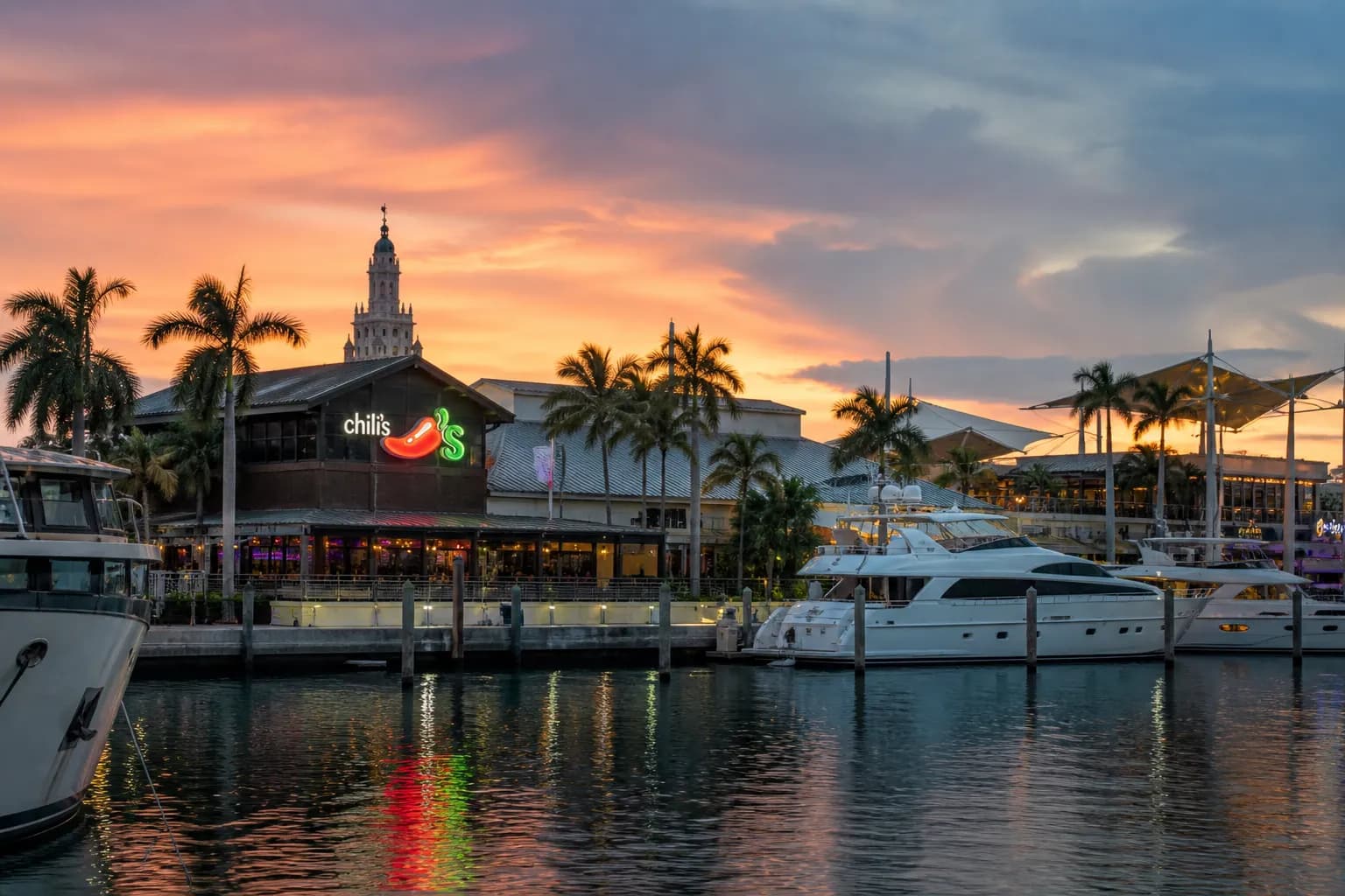 The iconic skyline of downtown Miami viewed across Biscayne Bay from the MacArthur Causeway during golden hour.