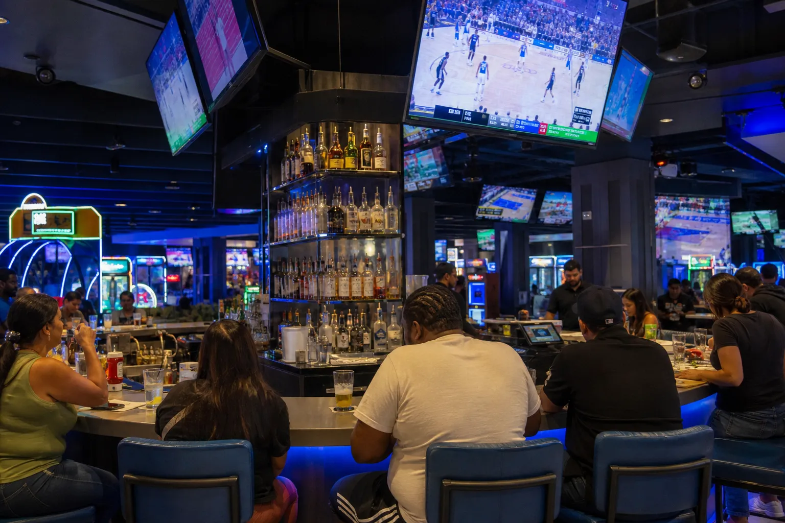 The brightly lit central sports bar and circular counter inside a modern Dave and Buster's entertainment center.