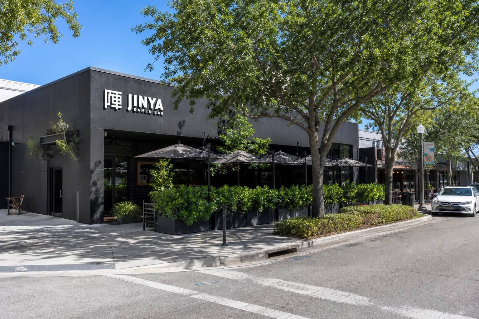 Exterior storefront of Jinya Ramen Bar on Miracle Mile with outdoor seating.