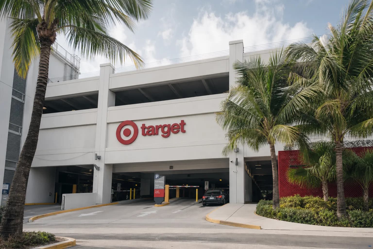 A bright, wide-angle shot of a Target aisle stocked with colorful beach towels, umbrellas, and outdoor gear in Miami.