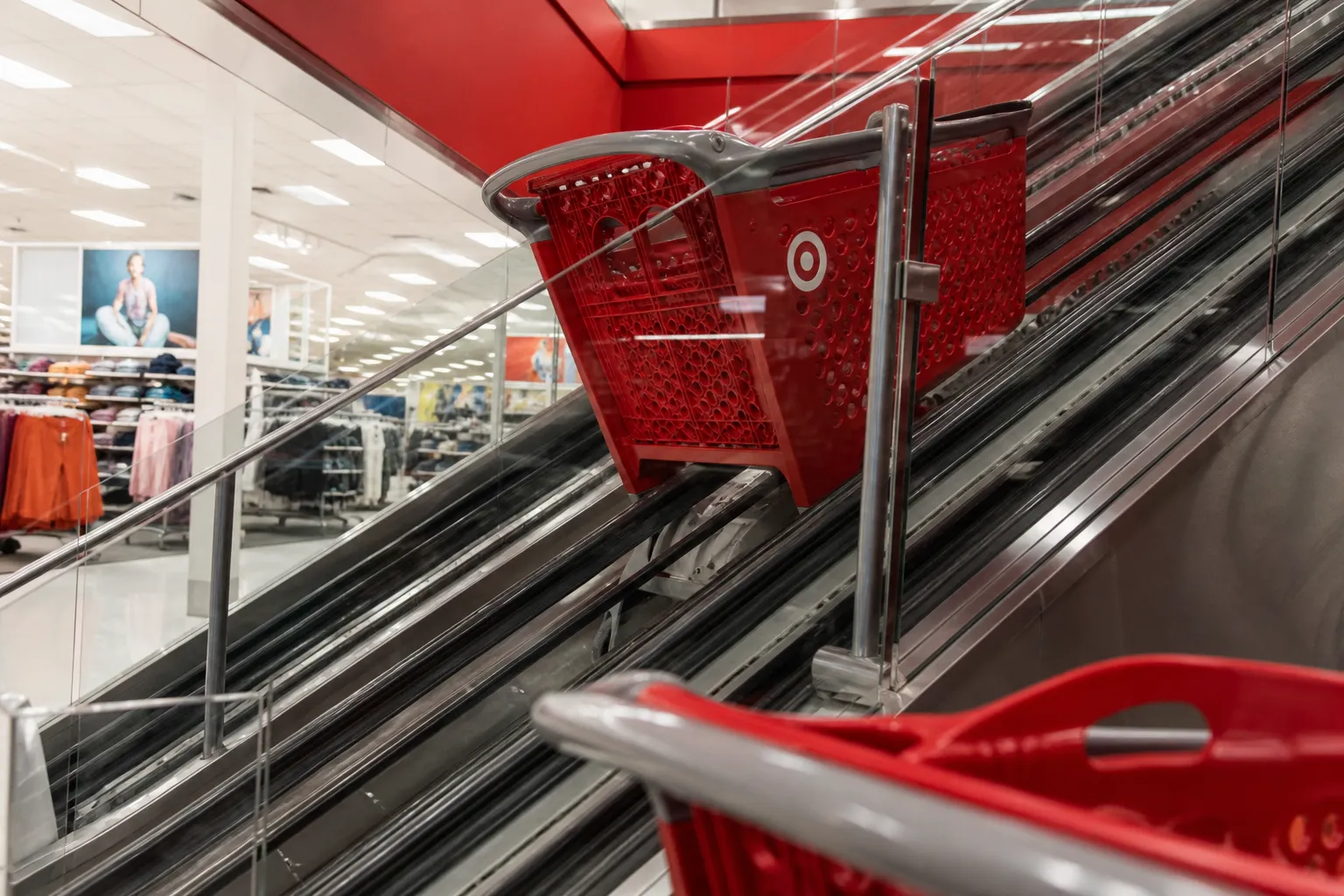 A modern shopping cart escalator inside a bright, two-story Target store in Miami.