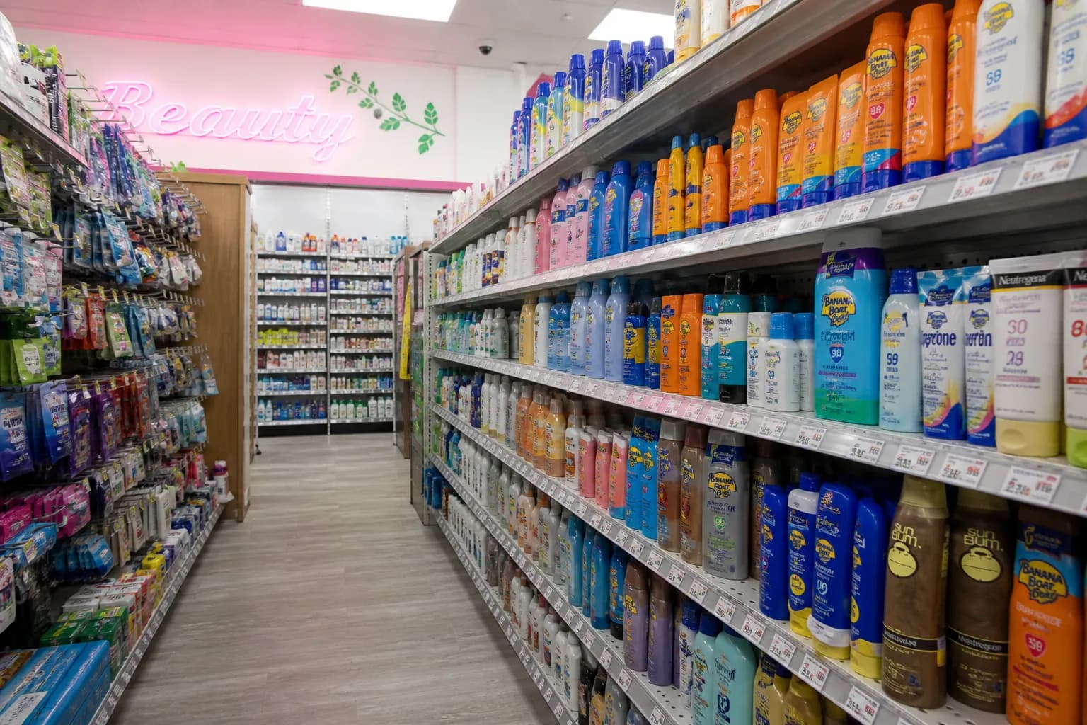 Brightly lit store aisle inside a Miami pharmacy showing sunscreen and health products.