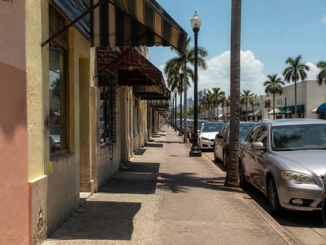 Calle Ocho storefronts and awnings under strong midday sun in Little Havana