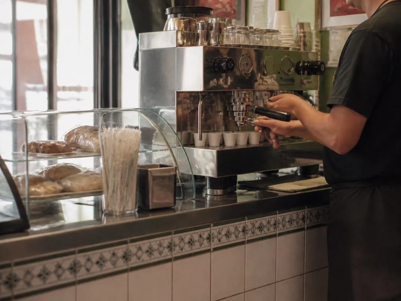 Small Cuban cafe counter with an espresso machine and stacked cups
