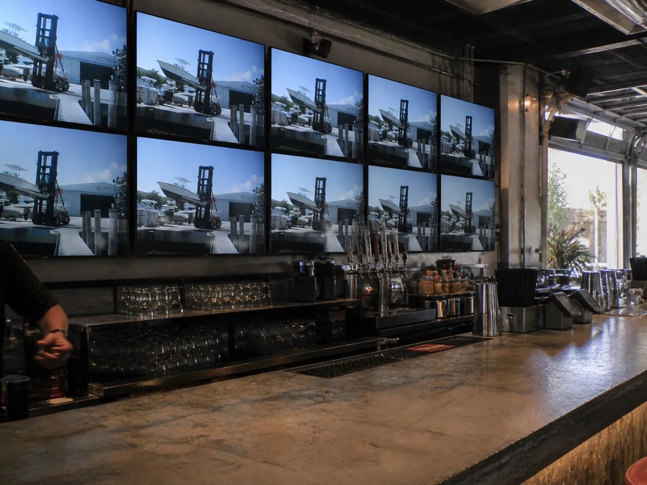 Bar counter with a wall of screens behind it