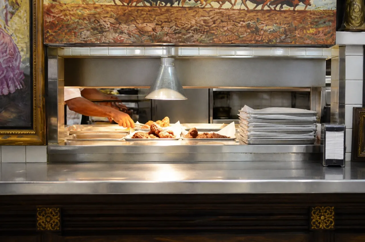 Order counter of a small fried chicken shop with menu board and trays
