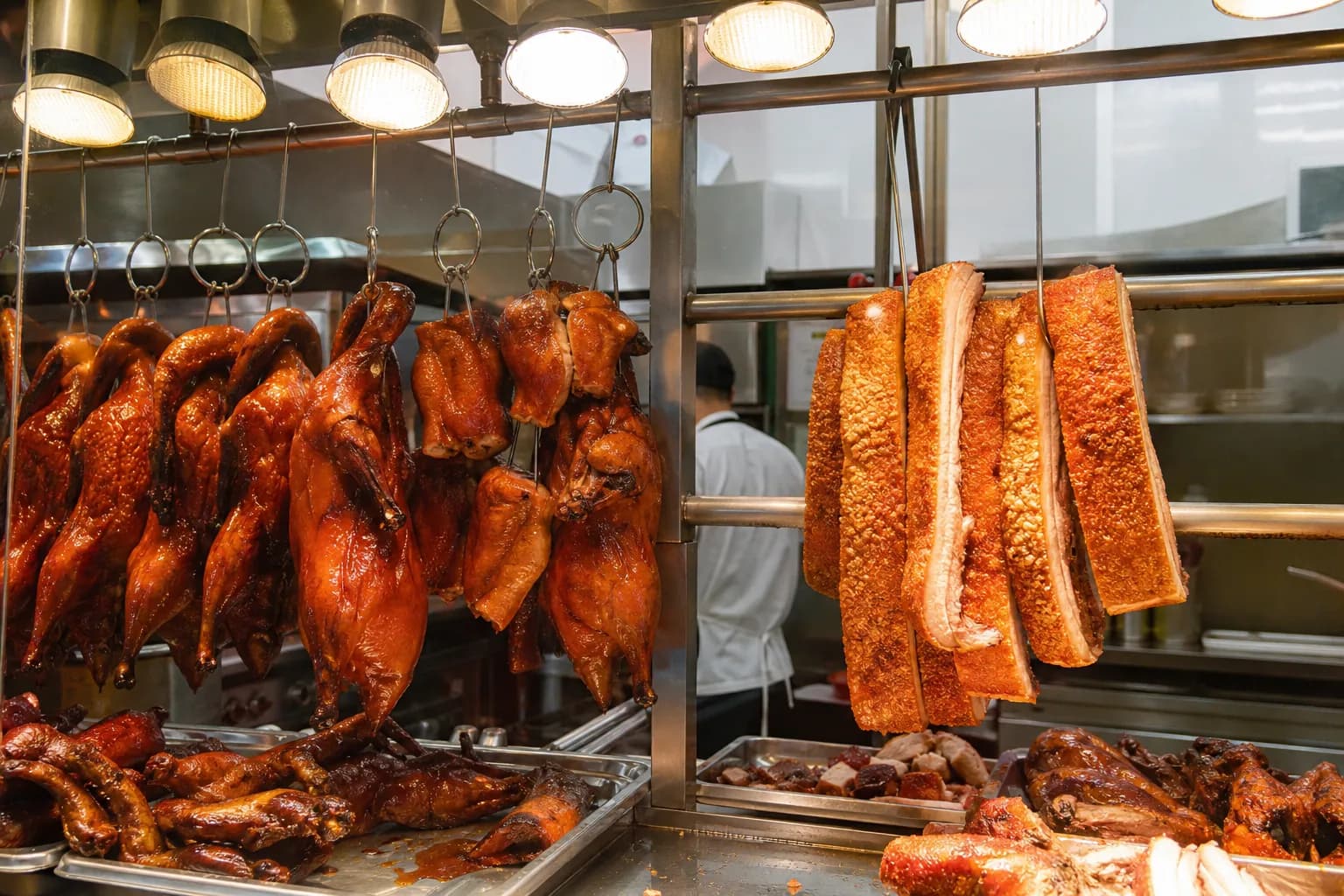 Hanging Cantonese roast ducks and crispy pork belly at the hot food counter in 99 Ranch Market.