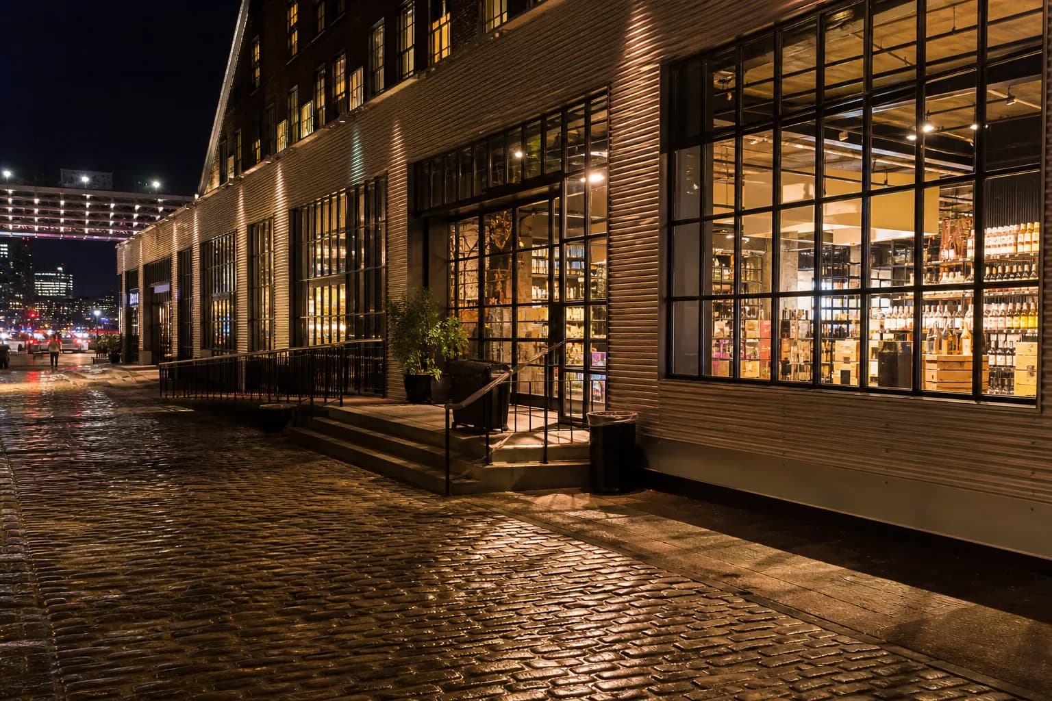 Night exterior of a modern wellness market in Manhattan with warm light spilling onto the sidewalk.