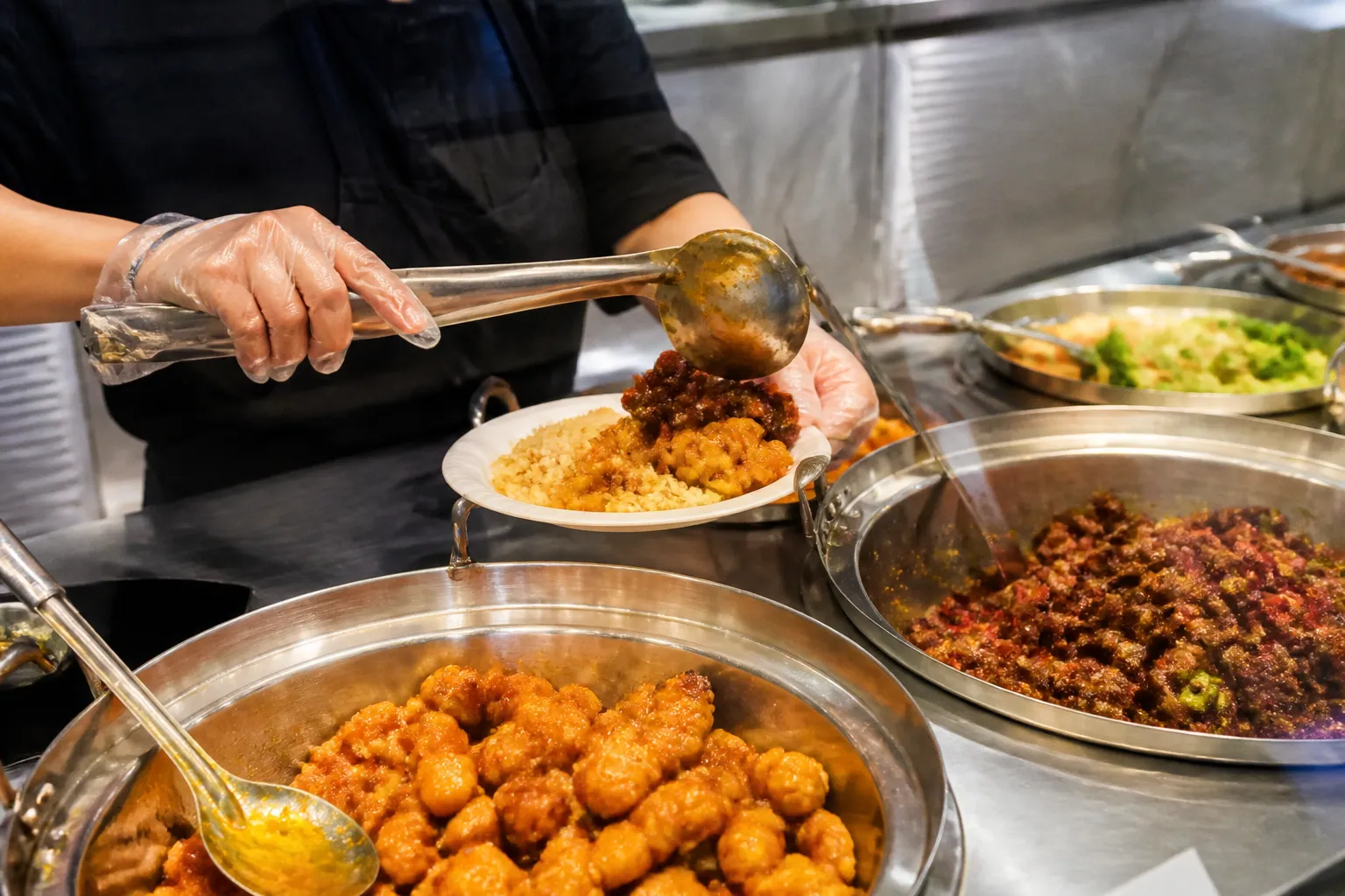 Fresh Orange Chicken being served at a busy Manhattan food counter.