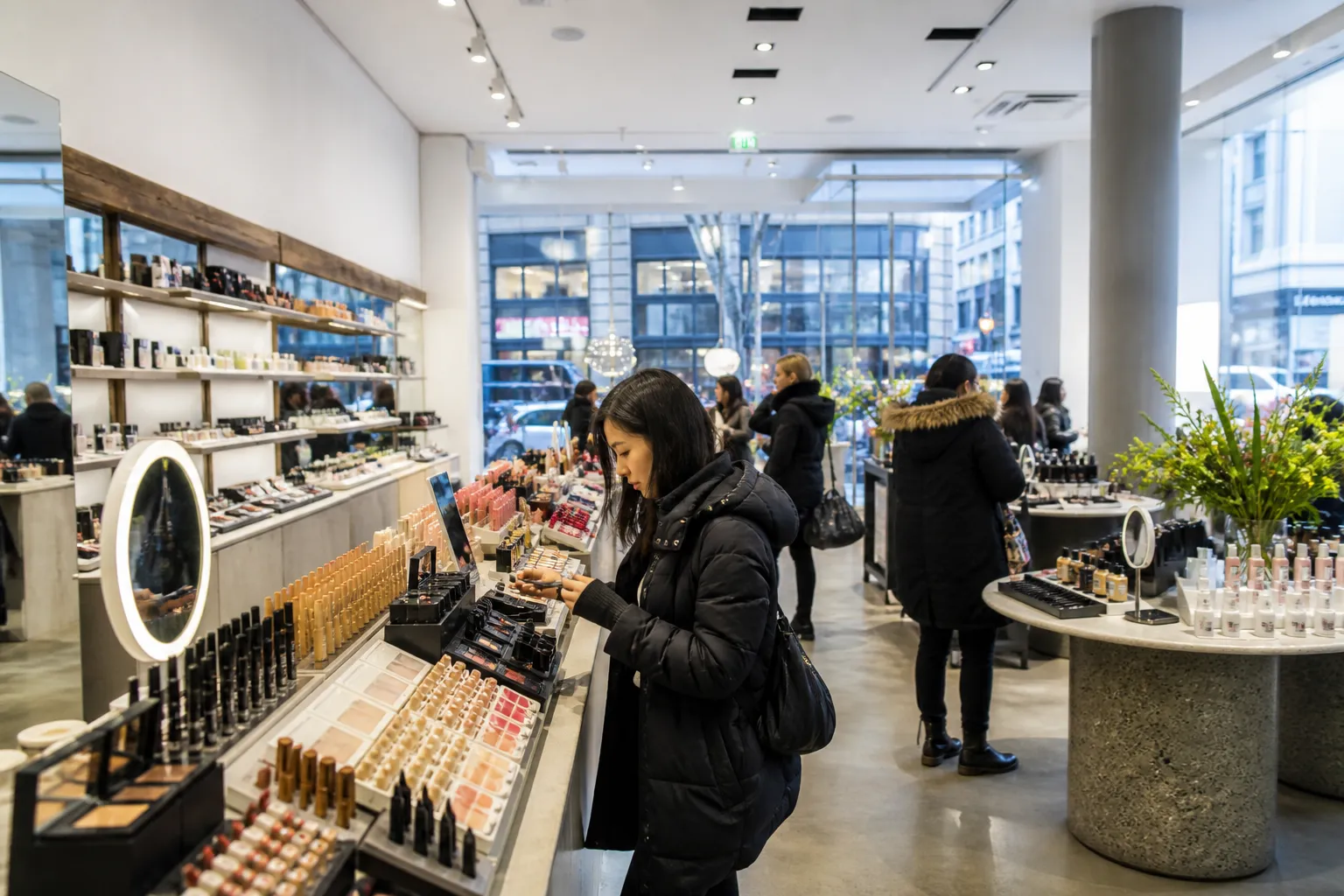The bright, spacious interior aisles of a large beauty and cosmetics store in New York City.