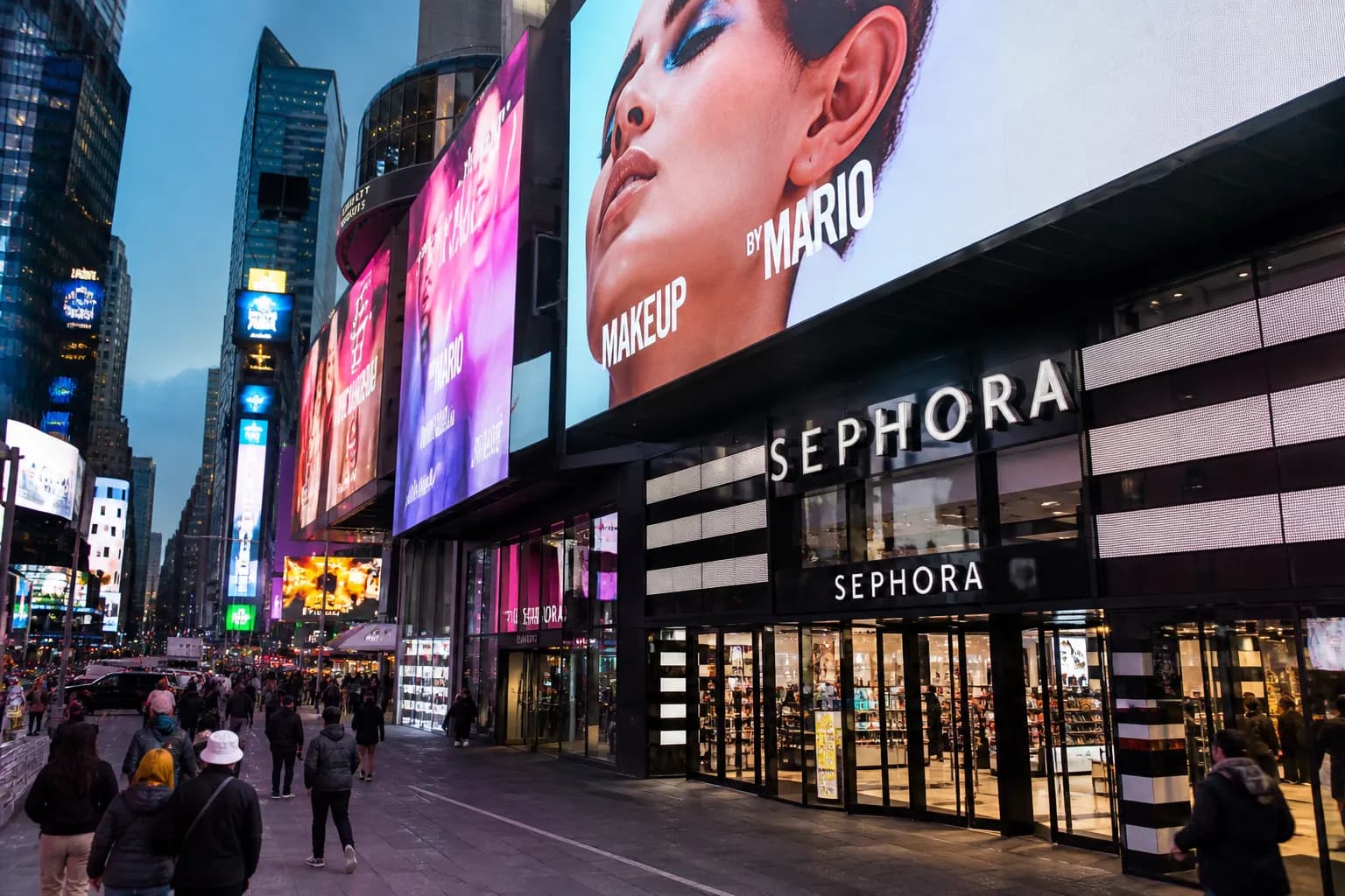The glowing storefront of Sephora in Times Square NYC under bright digital billboard displays.