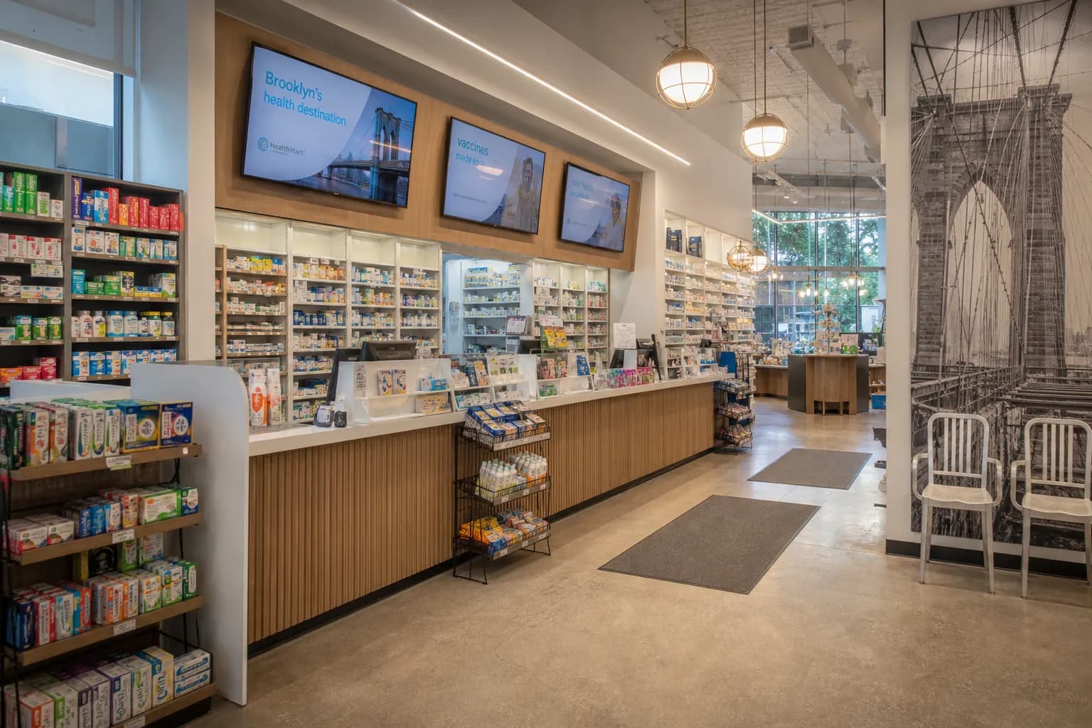 A brightly lit, modern pharmacy counter interior with clear signage.