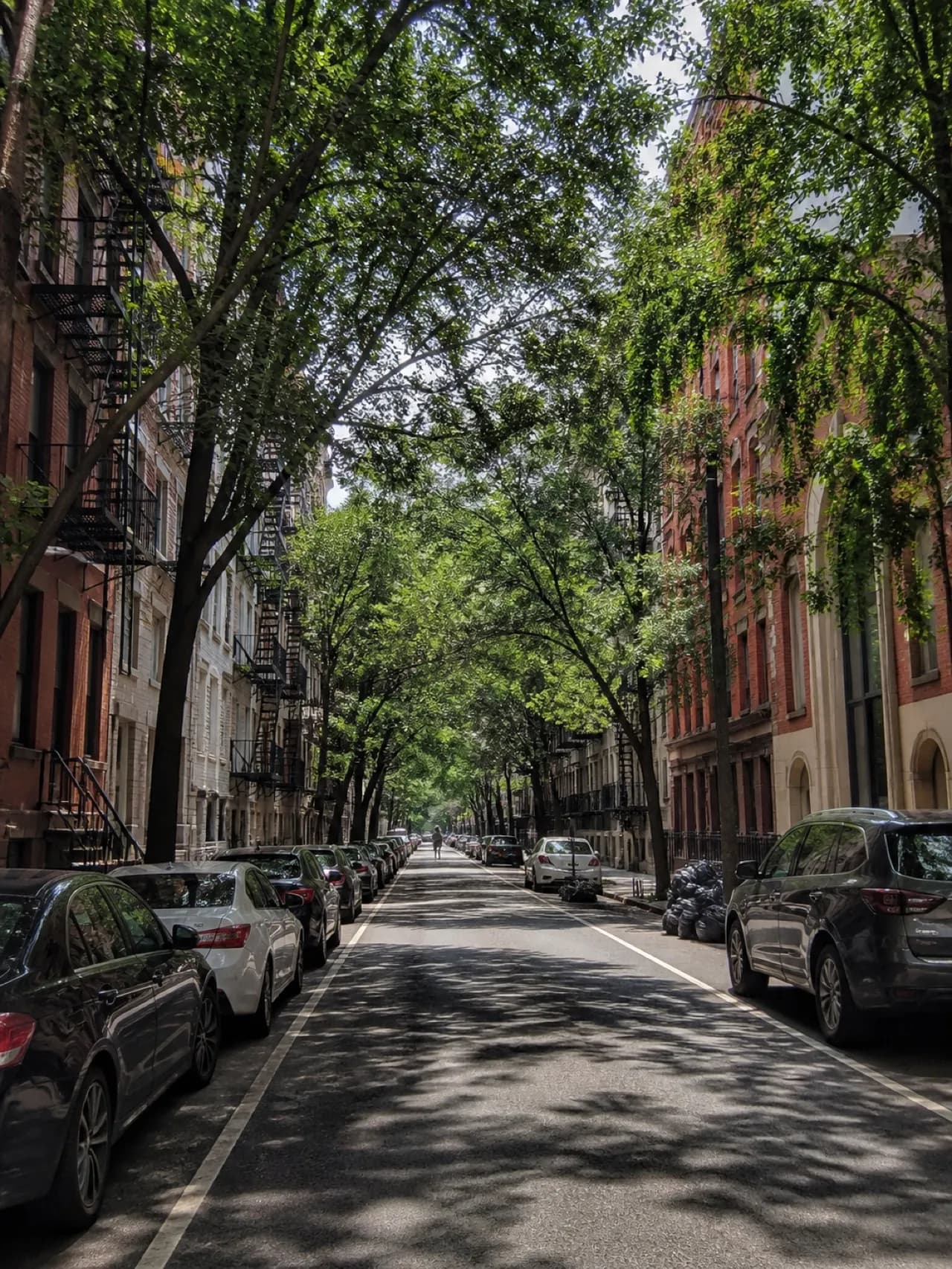 East Village side street with tenement facades and parked cars