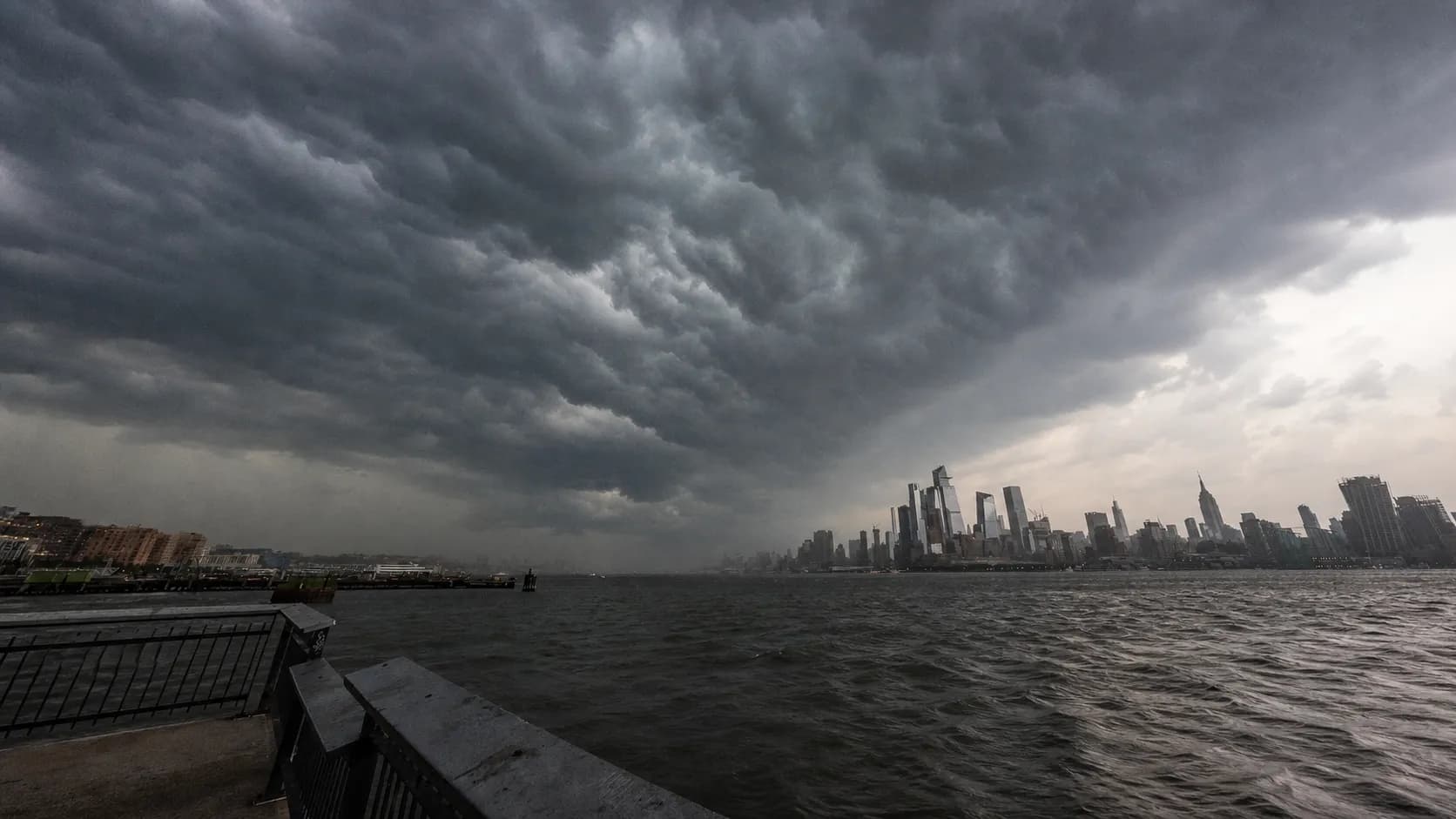 Severe storm clouds approaching the Manhattan skyline across the Hudson River