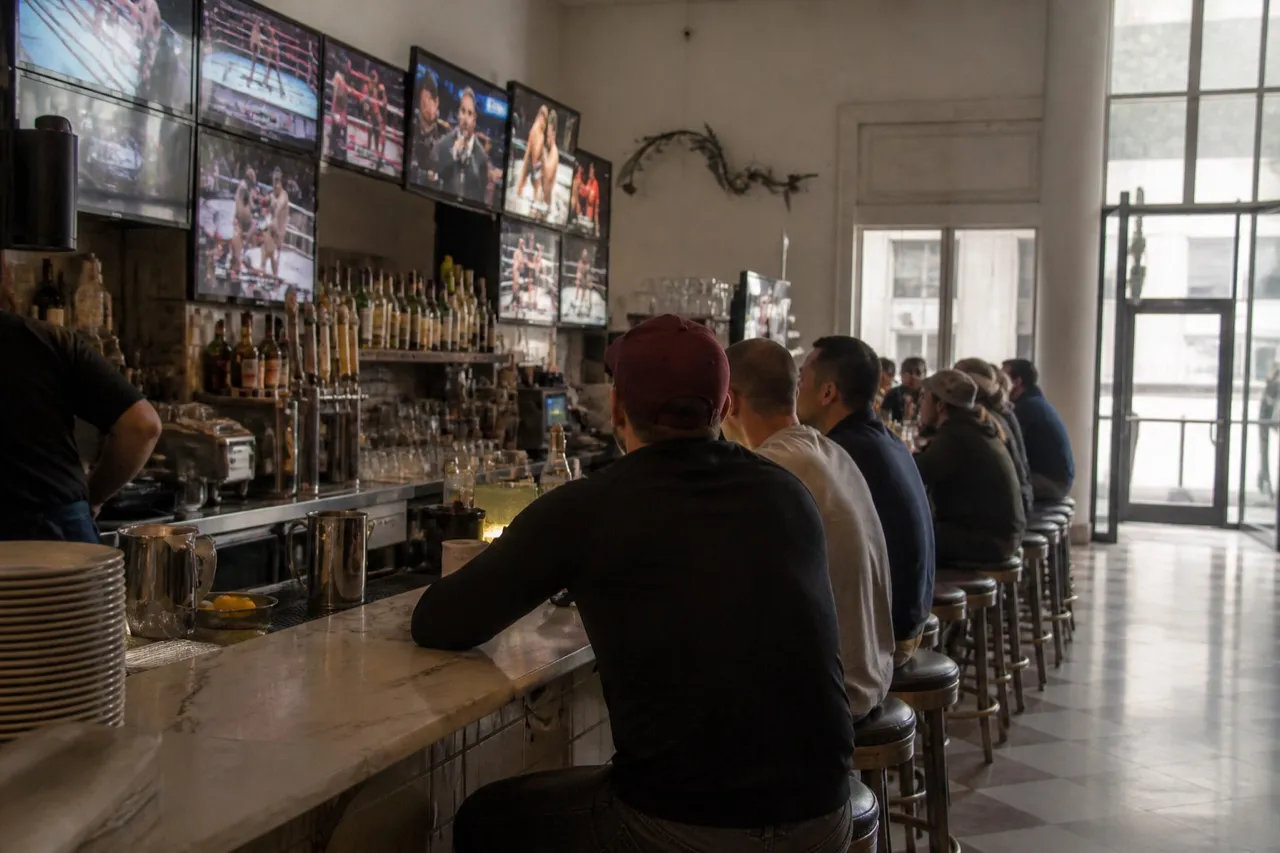 Bar counter with mounted screens showing a fight card