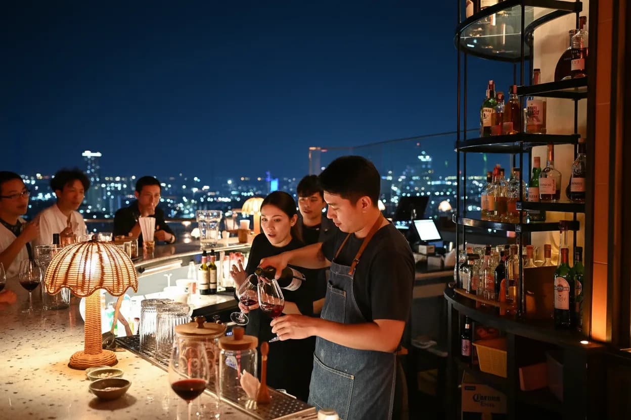 A lively small natural-wine bar on a weeknight, warm low light and people talking at the counter — the kind of place Karpo surfaces before you search