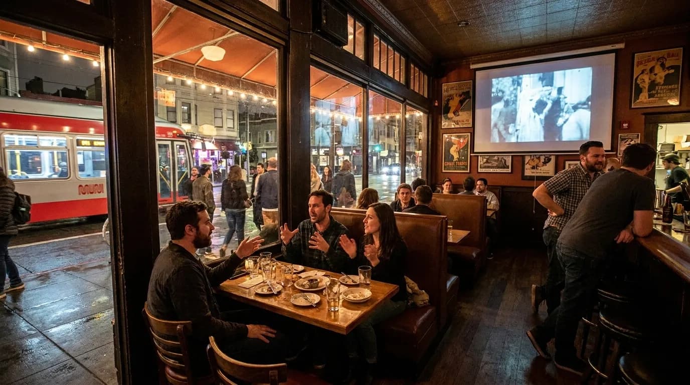 Dimly lit San Francisco bar interior with comfortable seating and film projection screen