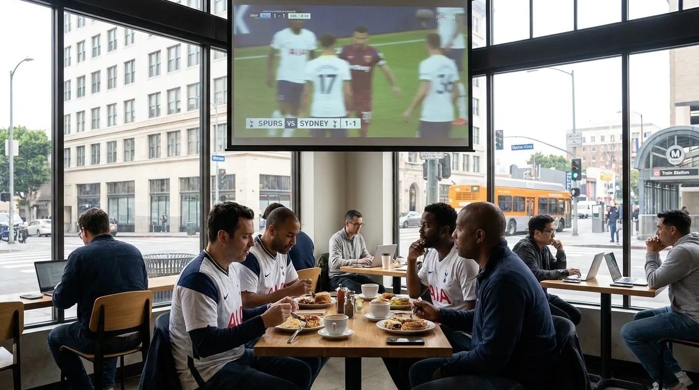 Restaurant dining room with television screens showing soccer match and breakfast service in Los Angeles