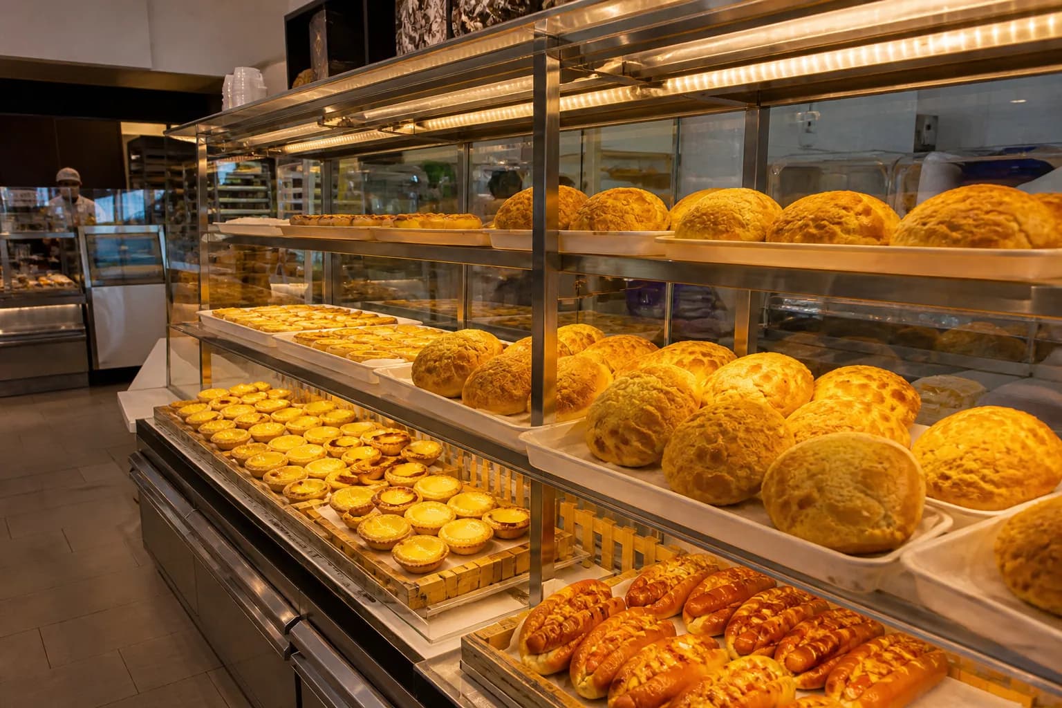 Freshly baked pineapple buns and egg tarts on display at the 99 Ranch Market bakery.