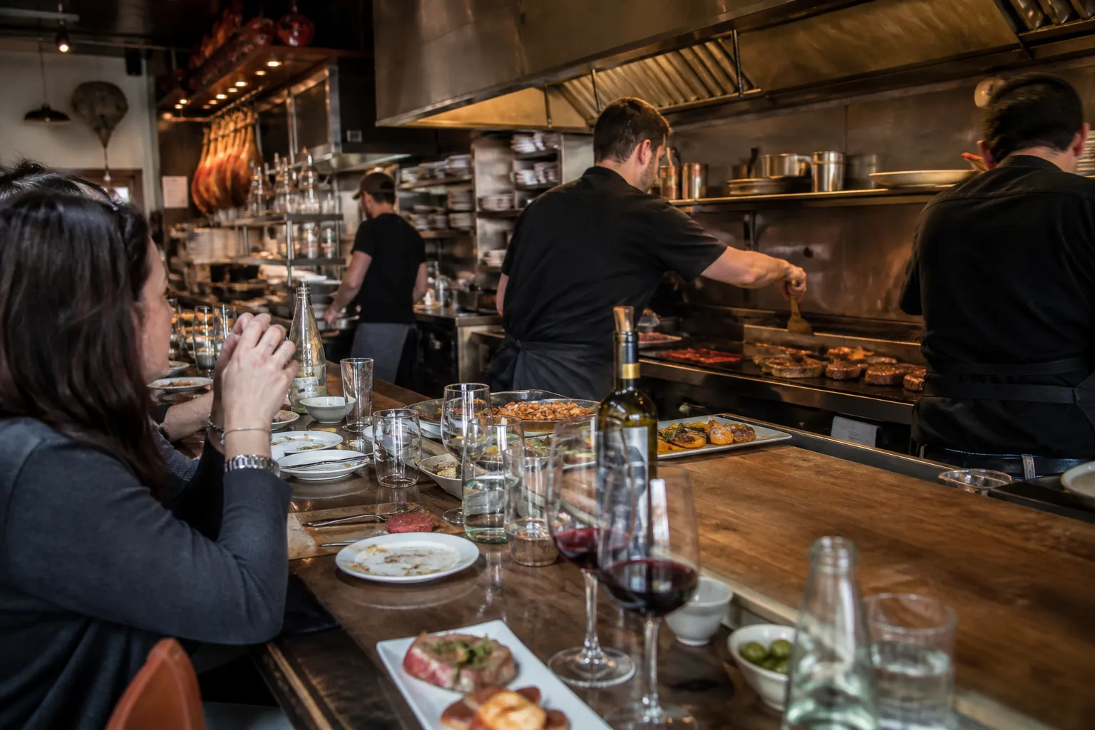 The bustling open kitchen and counter seating inside Barcelona Wine Bar on Valencia Street.
