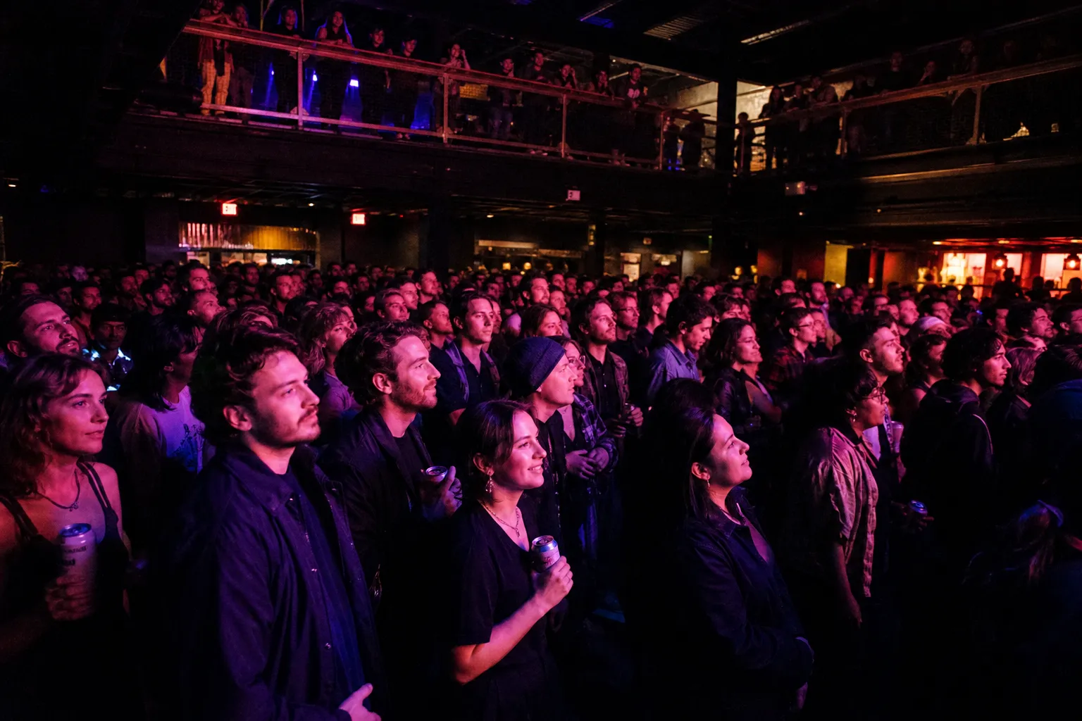A view from the back of the crowd looking toward the lit stage at The Independent music venue on Divisadero.