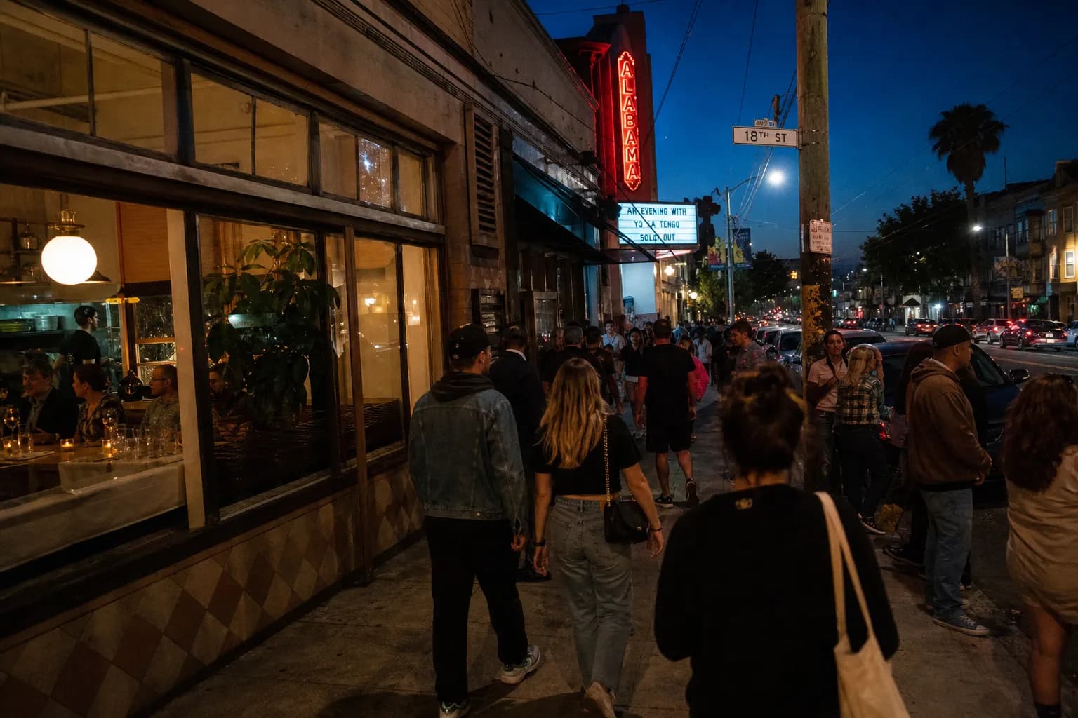 Mission District block in San Francisco with people walking toward a small concert venue