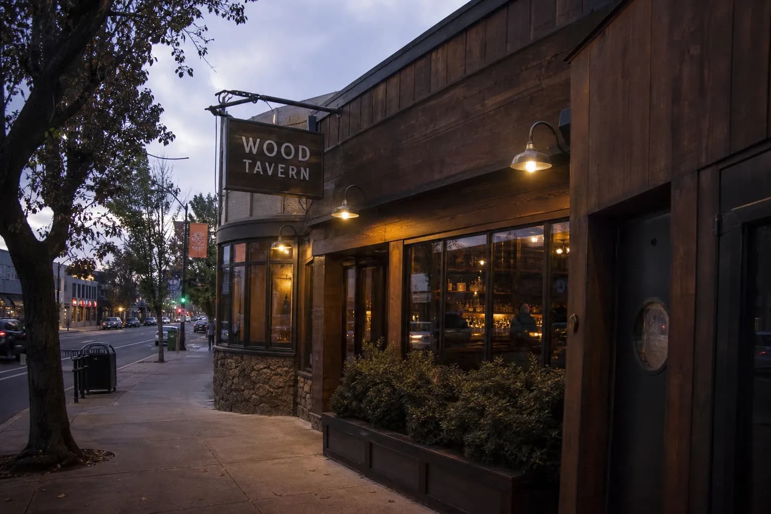 A wide establishing shot of a classic rustic wooden steakhouse storefront in California, catching the warm afternoon golden hour light.