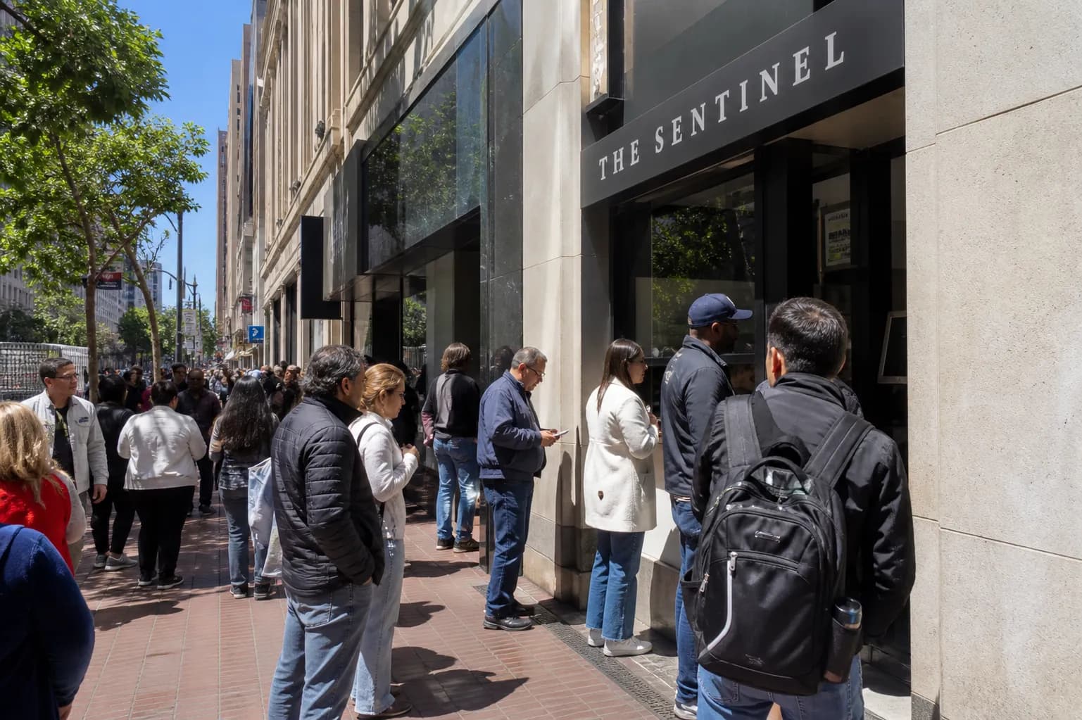 A small walk-up sandwich window on a busy brick-lined street corner in downtown San Francisco.