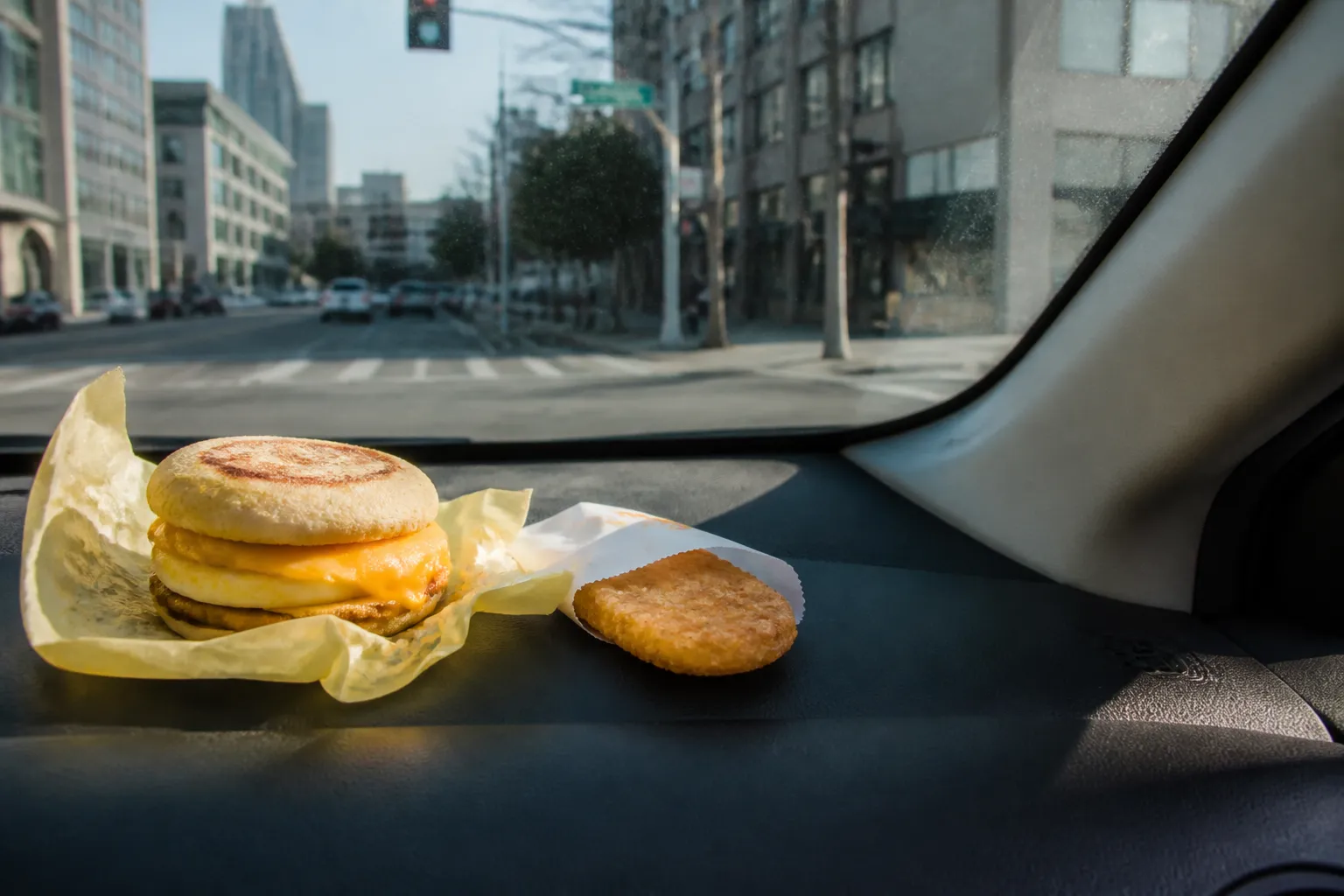 A hot McDonald's breakfast meal resting on a car dashboard in San Francisco.