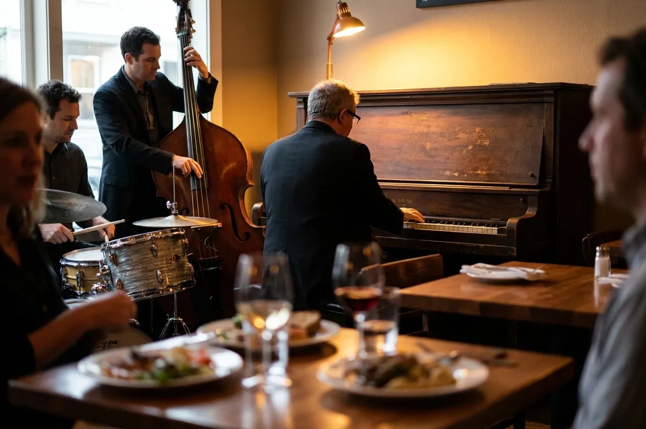 A jazz trio playing in the corner of a small San Francisco restaurant with upright bass, brushed snare and a battered piano seen from behind