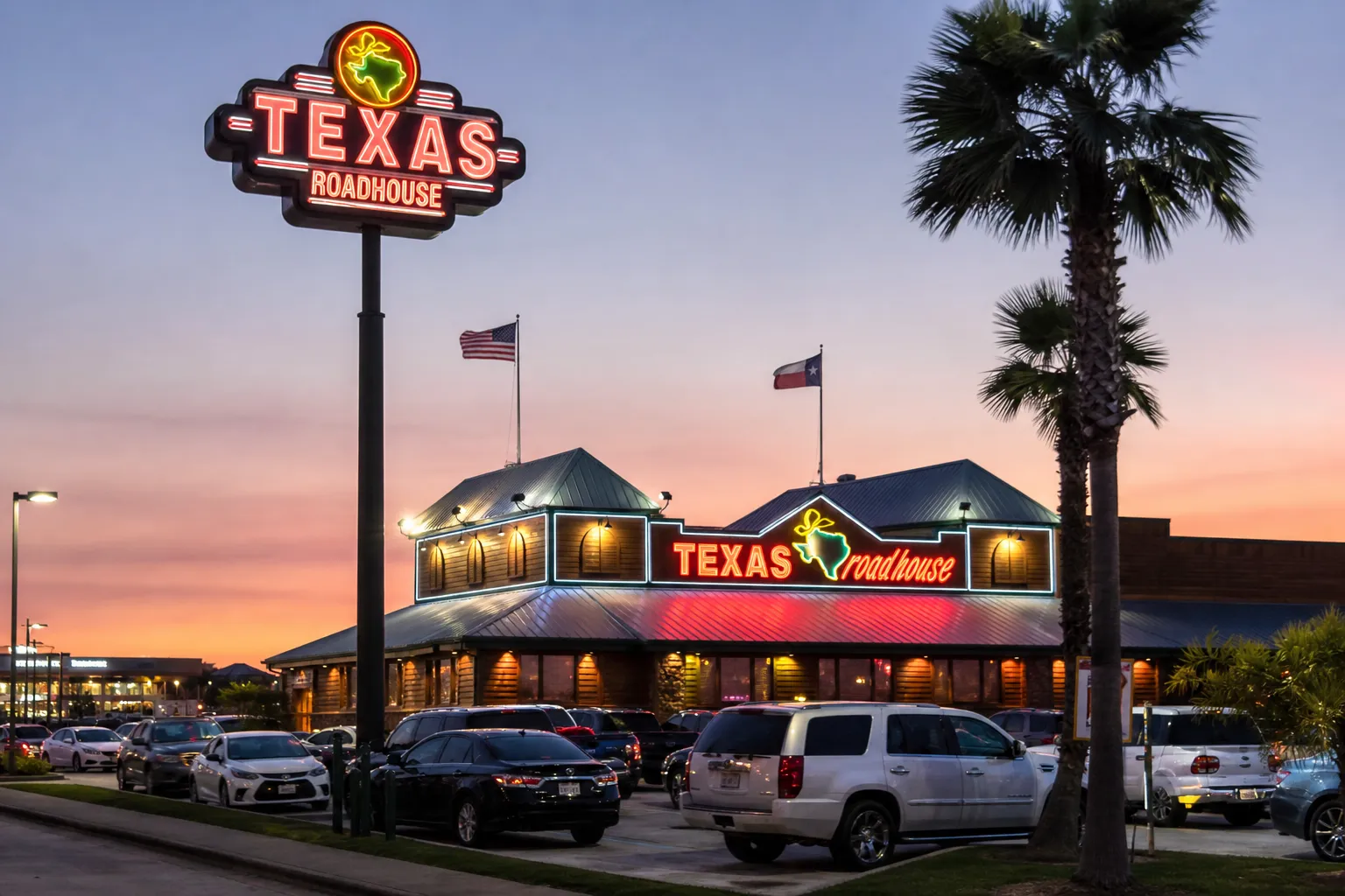The neon-lit exterior of the Union City Texas Roadhouse location.